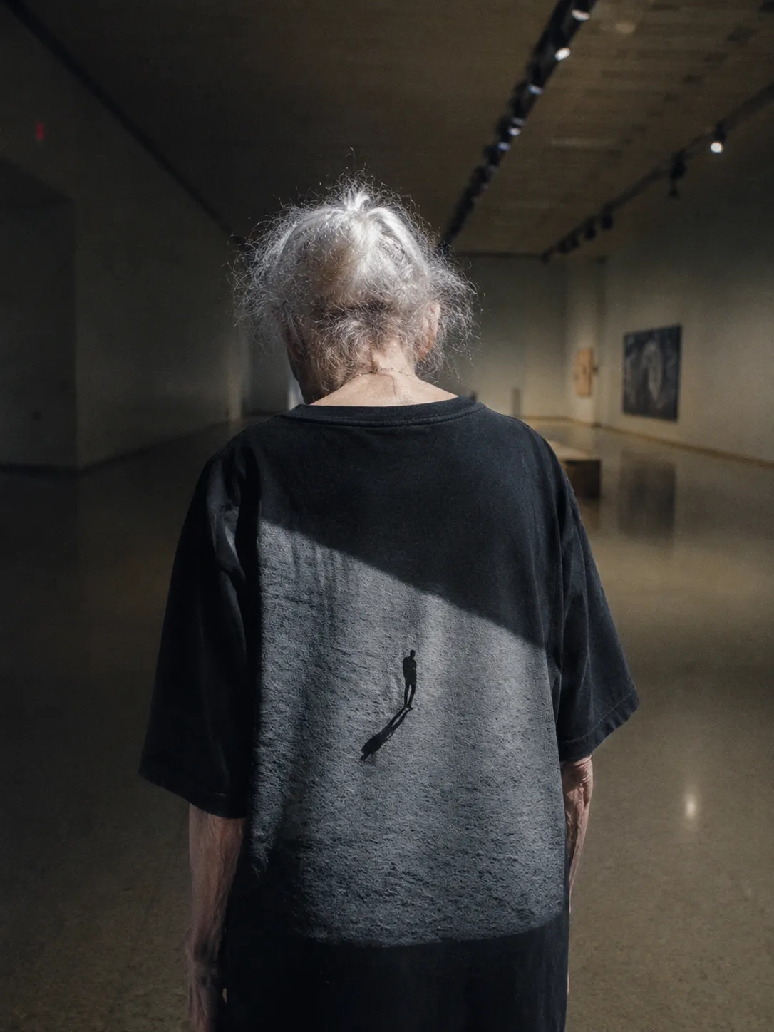 The VERTIGO tee worn, the print large across the back.